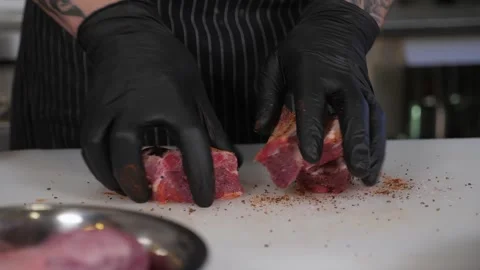 Close-up of the chef coating pork ribs with spices in the restaurant kitchen. Stock Footage 345132592