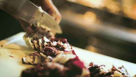Close up of chef cook cutting red cabbage vegetables with big sharp knife Stock Footage 103816398