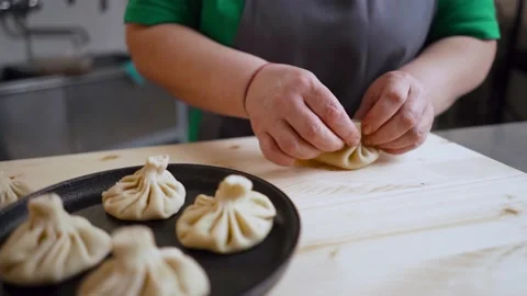 Close-up of chef cook hands making dumplings with meat in restaurant commercial Stock Footage 190579646