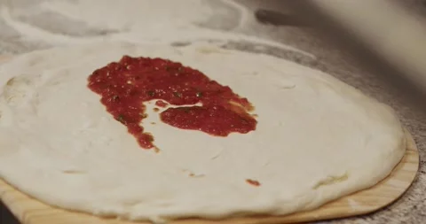Close up of chef cook spreading tomato sauce on dough Stock Footage 221633869
