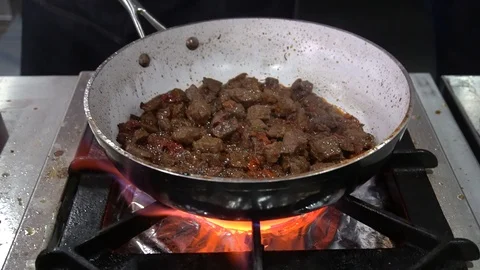 Close-Up Of Chef Cooking Meat In Wok Pan. Meat Fried In Boil Butter 库存影片 105885105