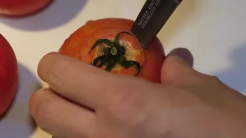 Close-Up of Chef Coring a Fresh Red Tomato with a Stainless Steel Knife Stock-Footage 347689283