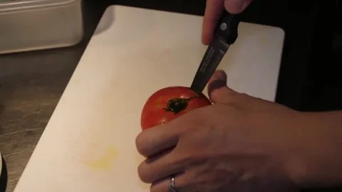 Close-Up of Chef Coring a Fresh Red Tomato on White Cutting Board Video stock 347689348