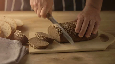Close Up Chef Cuts Bread On The Table With A Knife Stock Footage 67530736