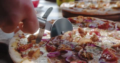 Close-up of chef cuts delicious pizza with round knife. Home delivery Stock Footage 148765844