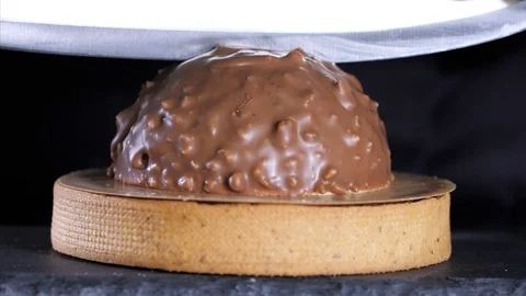 Close-up of chef is cutting a dessert with milk chocolate and nuts Stock Footage 126580817