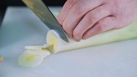 Close up of chef cutting leek Stock Footage 84280613