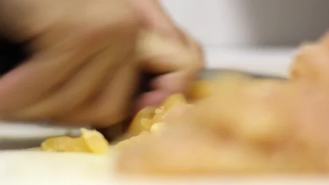 Close-up Of A Chef Cutting Raw Meat Stock-Footage 127885213