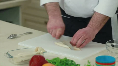 Close-up of a chef cutting squid. Frontal shot Stock Footage 50763018