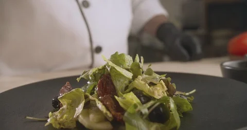 Close-up of chef decorating cooked salad. Slow motion video Stock Footage 114862492