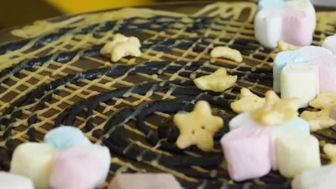 Close-up of Chef Decorating a Dessert with Marshmallows and Star Candies Video stock 345692558