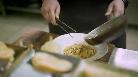 Close up of chef decorating spaghetti wtih fried onion Stock Footage 121851115