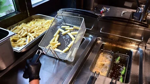 Close-up of chef deep frying potatoes 스톡 동영상 327114315