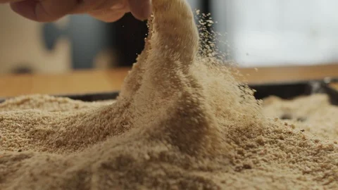 Close-up of chef dipping fresh shrimp into breadcrumbs on kitchen table. Slow Stock Footage 116162874