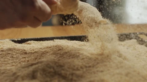 Close-up of chef dipping fresh shrimp into breadcrumbs on the kitchen table Stock Footage 116162916