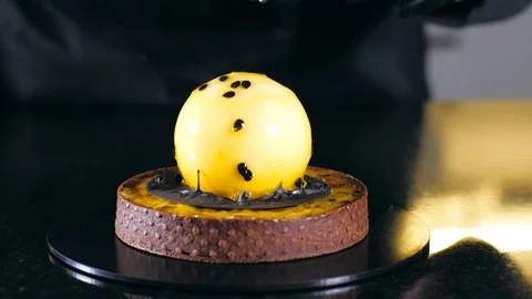 Close-up of chef is finishing make dessert with passion fruit Stock Footage 124889623