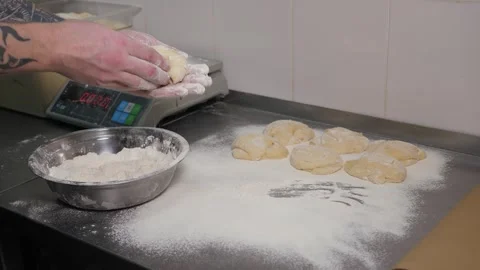 Close-up of the chef forming a round burger bun from raw dough in the kitchen. Stock Footage 344038405