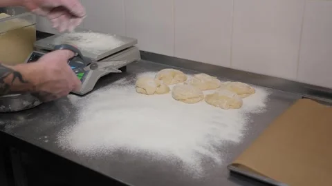 Close-up of the chef forming a round burger bun from raw dough in the kitchen. Stock Footage 345131819