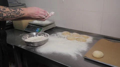 Close-up of the chef forming a round burger bun from raw dough in the kitchen. Stock Footage 346442980