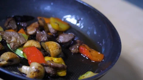 Close-up. chef frying vegetables in pan. mixed colorful vegetables tossing them Stock Footage 126771453