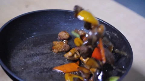Close-up. chef frying vegetables in pan. mixed colorful vegetables tossing them Stock Footage 126771463