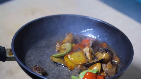 Close-up. chef frying vegetables in pan. mixed colorful vegetables tossing them Stock Footage 126771477