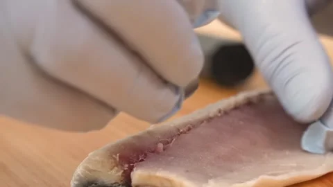 Close-up of Chef in Gloves Preparing Fresh Fish Fillet Stock Footage 333500530