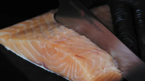 Close-up of a chef in gloves slicing fresh salmon. Stock Footage 170462197