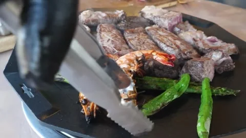 Close-up of Chef Grilling Surf and Turf Platter with Beef Steak and Jumbo Prawns Видео 338210890