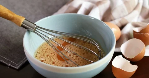 Close up chef hand braking an egg into a blue bowl then mix to prepare omelet Stock Footage 91801791