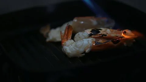 Close up of chef hand burning shrimp on serving plate in restaurant Stock Footage 145449185