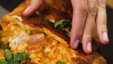 Close-up of chef hand taking a delicious piece of pizza with salami pickles Stock Footage 136668785