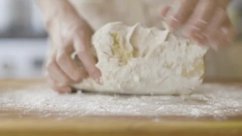 Close-up of chef hands baker preparing bread dough kneading raw dough on wo.. Stock Footage 272468415