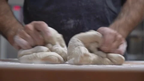 Close-up of chef hands baker preparing bread dough kneading raw dough on wo.. Stock Footage 272468440