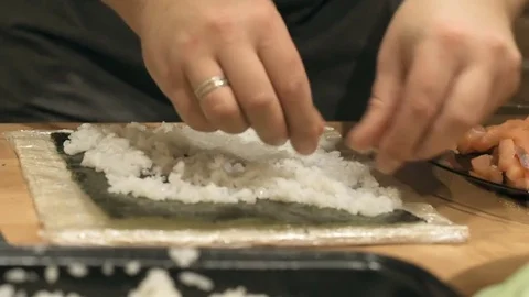 Close-up of chef hands cooking and preparing Asian food and sushi in restaurant Video stock 69787594