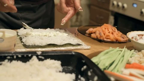 Close-up of chef hands cooking and preparing Asian food and sushi in restaurant Video stock 69787648