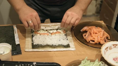 Close-up of chef hands cooking and preparing Asian food and sushi in restaurant Video stock 69787743