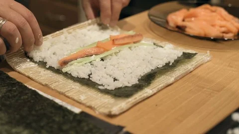 Close-up of chef hands cooking and preparing Asian food and sushi in restaurant Video stock 69787808