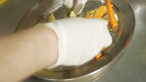 Close-up of chef hands cooking and preparing potato with carrots Stock Footage 78486527