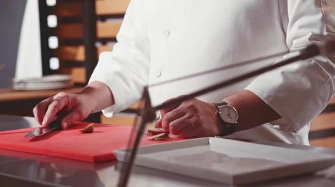 Close-up of chef hands cooking food in restaurant kitchen. Slow Motion. Stock Footage 53897005