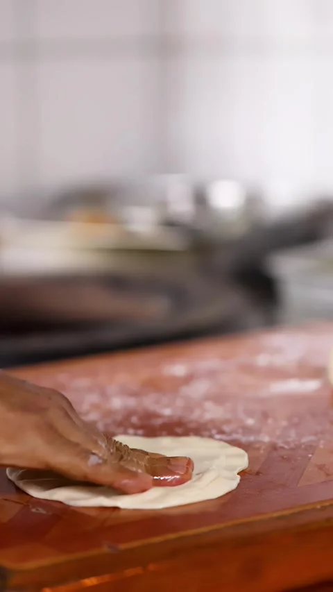 Close Up of Chef Hands Flattening Roti Dough on Wooden Board Stock Footage 339423430