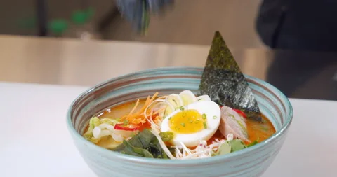Close-up of a chef hands in gloves preparing delicious ramen with chicken, egg Stock Footage 150661397