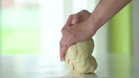 Close-up of chef hands kneading raw dough on a table. Concept of baking Stock Footage 136352406