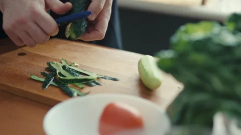Close Up of Chef Hands Peeling Green Cucumber in Modern Kitchen Stock-Footage 347131671