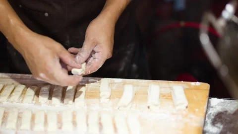 Close Up of Chef Hands Preparing Dough for Fried Bread Sticks Video stock 340191066