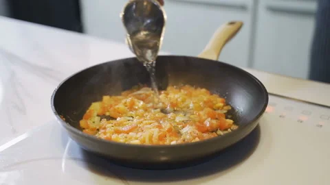 Close up of a chef hands preparing an Italian penne pasta addict tomato sauce on Stock Footage 102701535