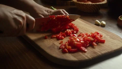 Close up of chef hands slicing red bell pepper on wooden board. Stock Footage 343554283
