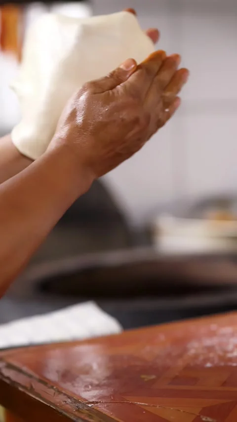 Close Up of Chef Hands Stretching Roti Dough for Cooking Stock Footage 339752352