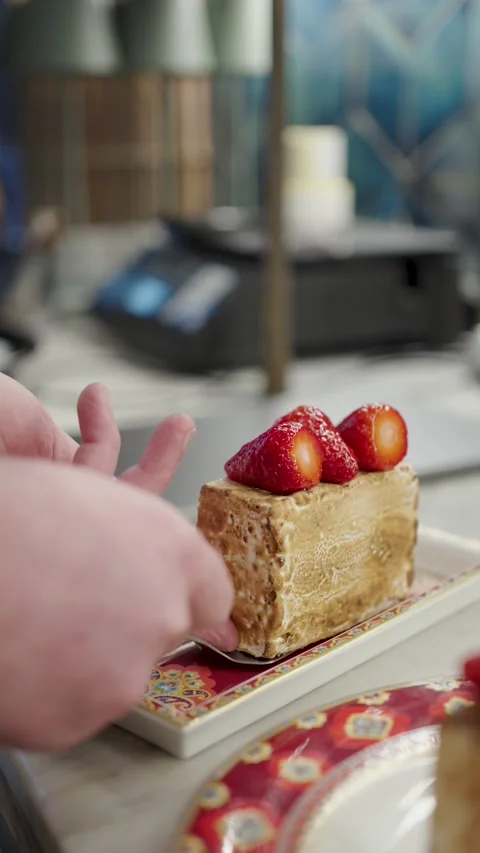 Close-up of a chef hands using a spatula to carefully place a slice of gour.. Video stock 333915311