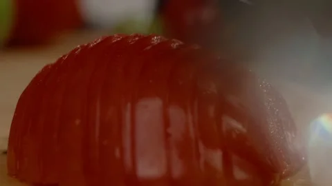 Close-up of a chef holding a sharp steel knife through sliced tomatoes Stock Footage 168822298